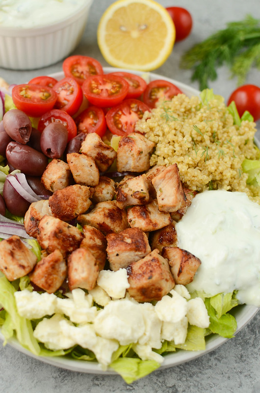 Pork Gyro Salad - easy, healthy, and delicious dinner idea! Lots of veggies with garlic and herb marinated pork all topped with a quick homemade tzatziki sauce. 