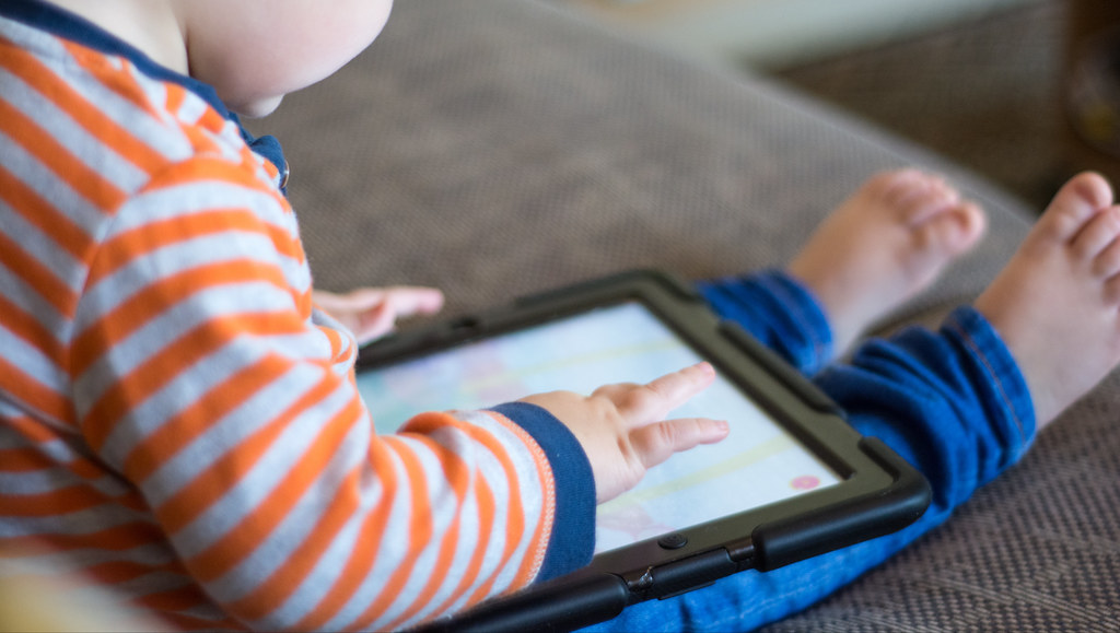 Image of child using a tablet.