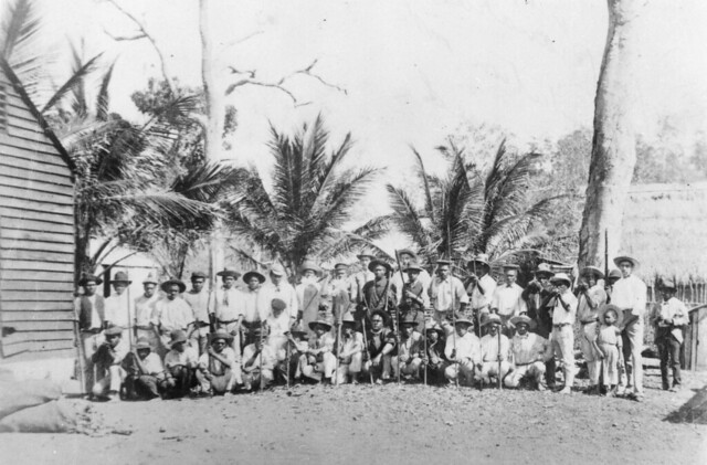 Group of Australian South Sea Islander workers with an overseer on a plantation in Mackay Queensland ca 1890