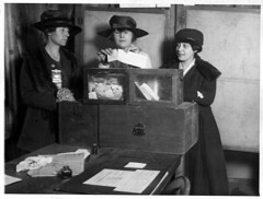Three suffragists casting votes in New York City