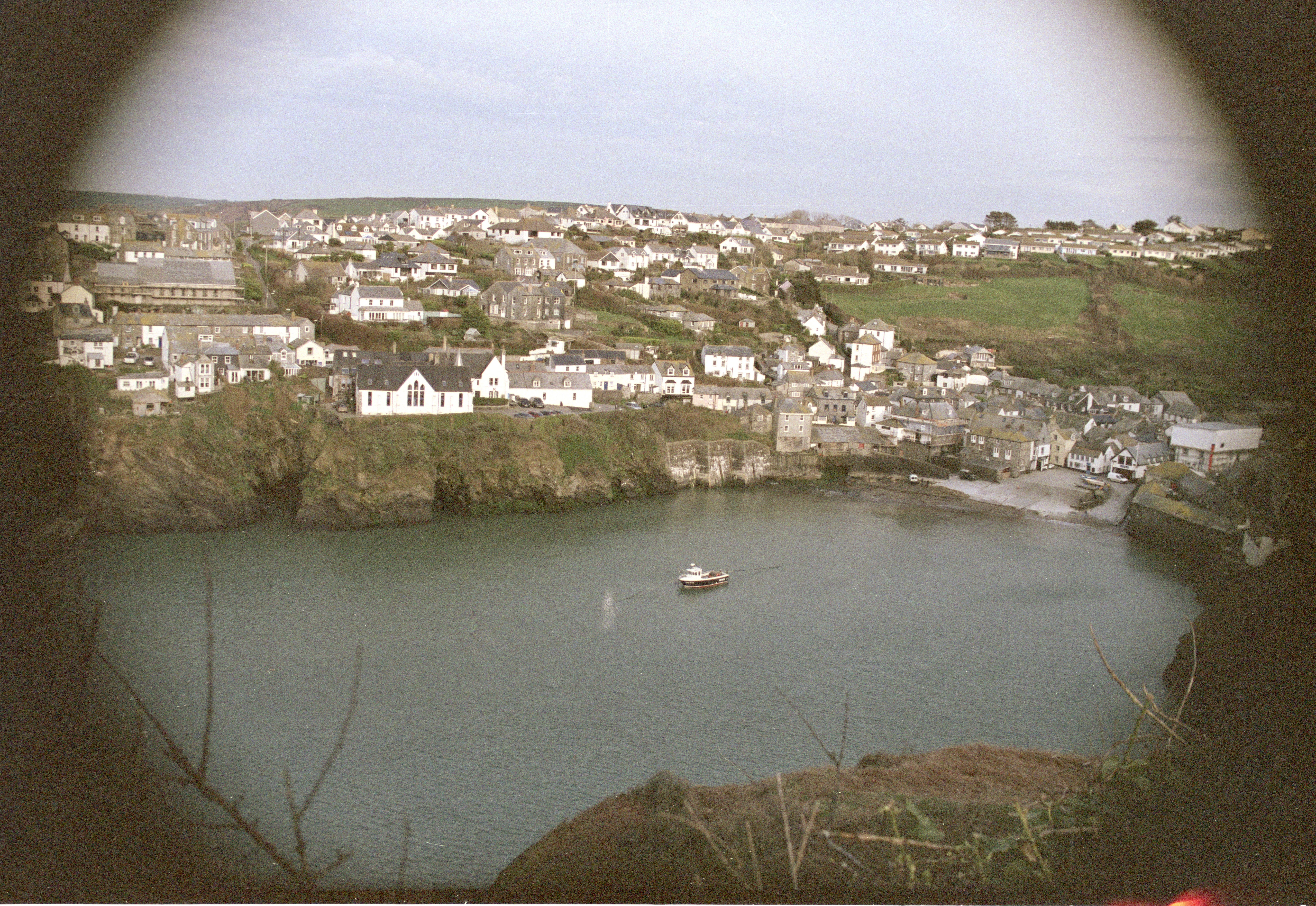 Port Isaac with a boat in film vignetting