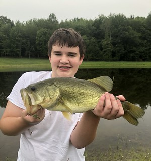 Photo of young angler holding a largemouth bass