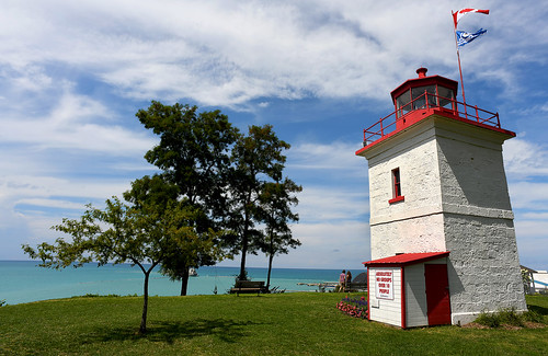 goderichlighthouse lighthouse redandwhite canada ontario goderich clouds sunny cliff couple benches water lake lakehuron lovely prettyview history nikon d850 flickrclickx tree canadianflag