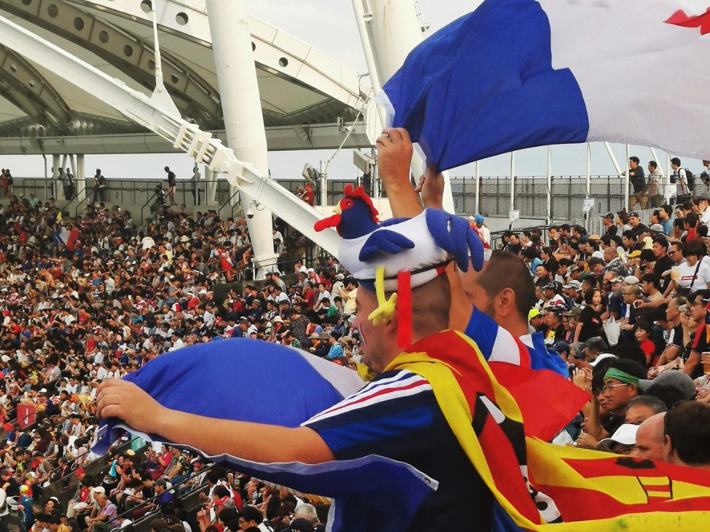 French fan with rooster hat in Egao Kenko Stadium during RWC match