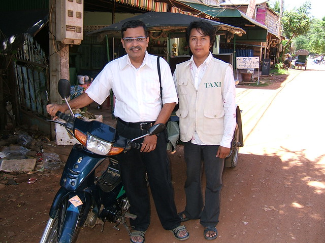 My tuk tuk driver guide poses with me in front of my guest house