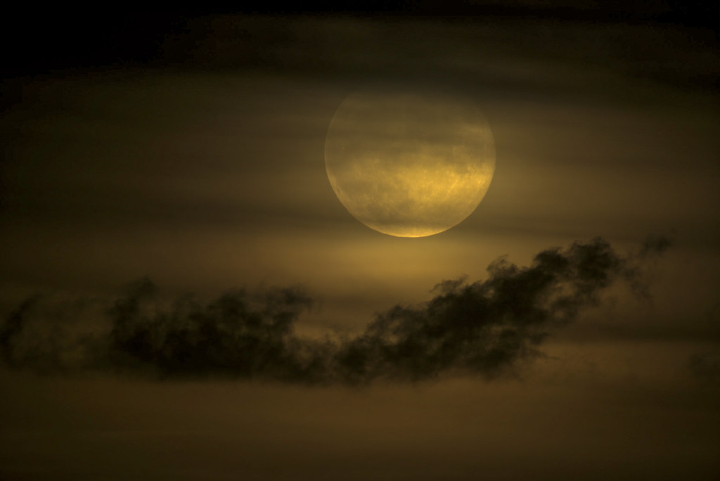 Sept Full Moon Rising; seen at 1000mm rising up over the horizon through the clouds.