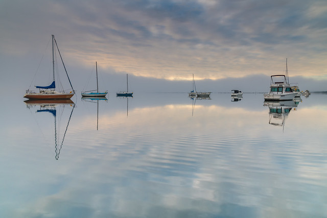 Misty Morning with Boats and Reflections on the Bay