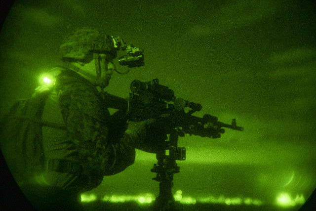 A Marine assigned to the 31st Marine Expeditionary Unit (MEU) aboard the forward-deployed amphibious assault ship USS America (LHA 6) provides security during a Beach Reconnaissance exercise.