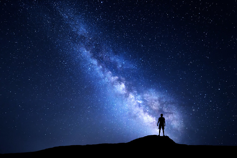 Milky Way and silhouette of alone man. Night landscape