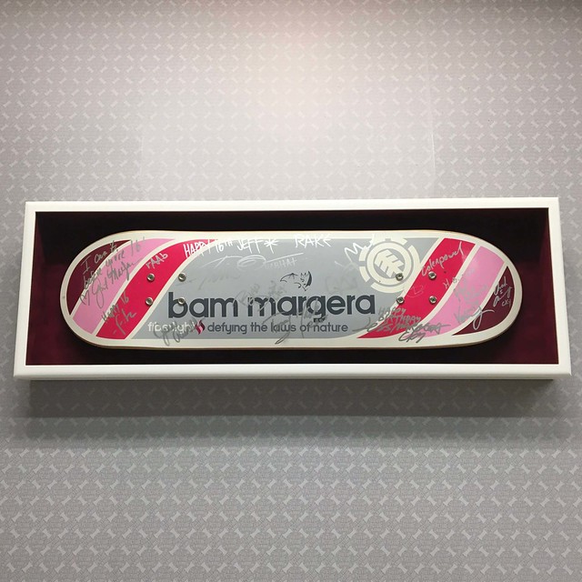 Signed “Bam Margera” skateboard deck - presented in a closed corner Jonah shadowbox lined with Crescent maroon suede, and topped off with TruVue Museum glass.