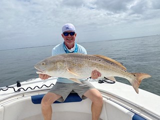 Photo of man holding a large red drum
