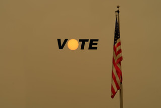 Everett, WA - USA /09/12/2020: Yellow Brown Smoke in sky covers sun in foreground an American Flag - Smoke From the Northwest Fires 2020 - the words vote. | by ShebleyCL