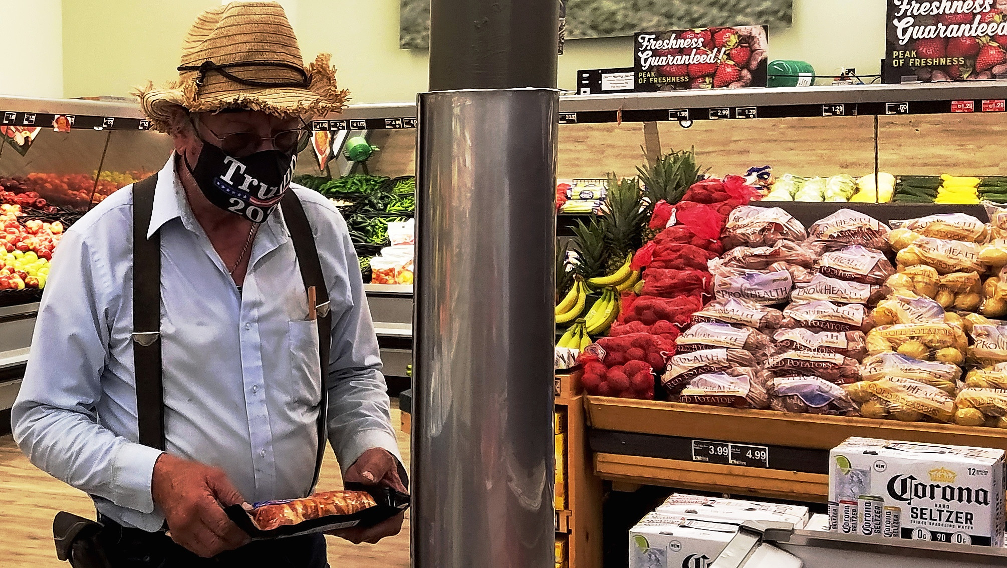 Man with a straw hat & a Trump 2020 COVID-19 face mask at supermarket
