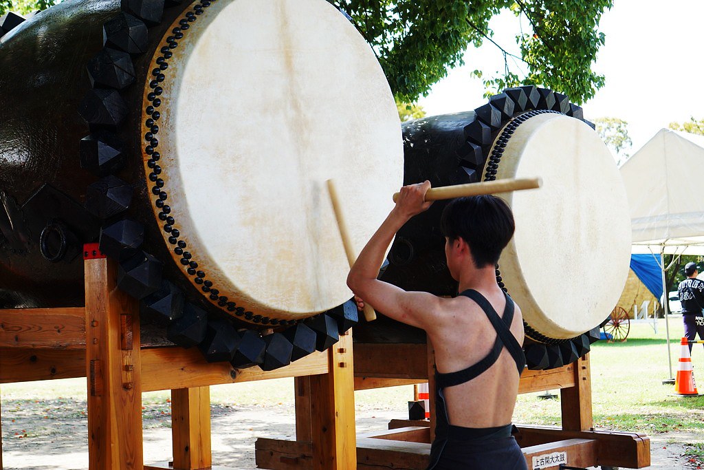Japanese guy playing taiko drum at a festival outside Kumamoto Castle