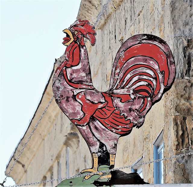 A great old cafe sign.  A red rooster.