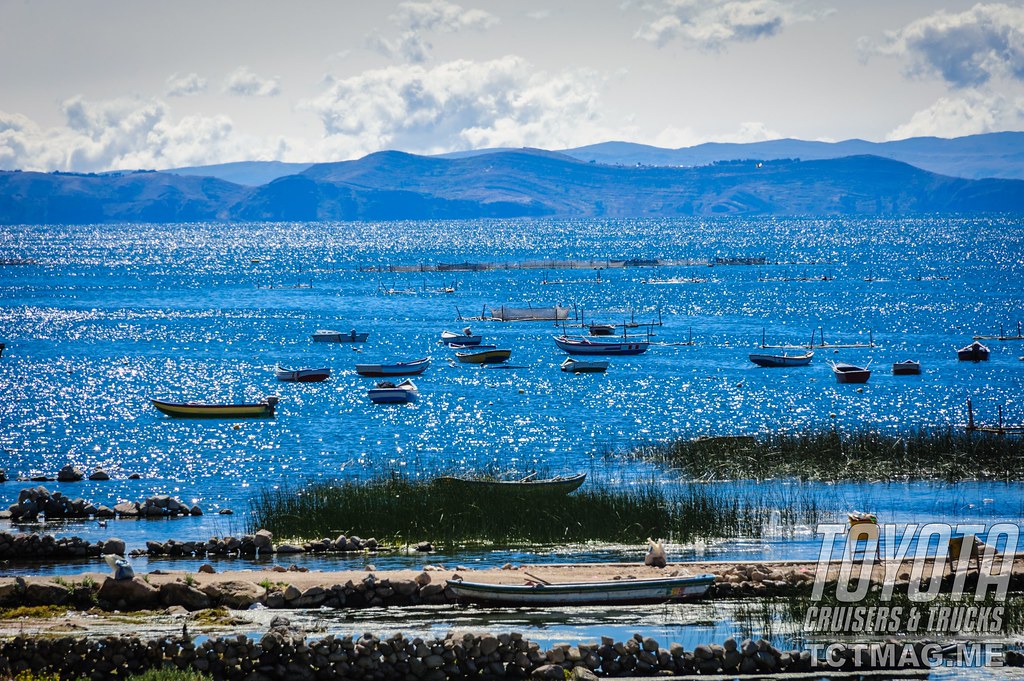 Cobalt-blue waters of Lake Titicaca with the sun glistening and the wind sending ripples over the surface.