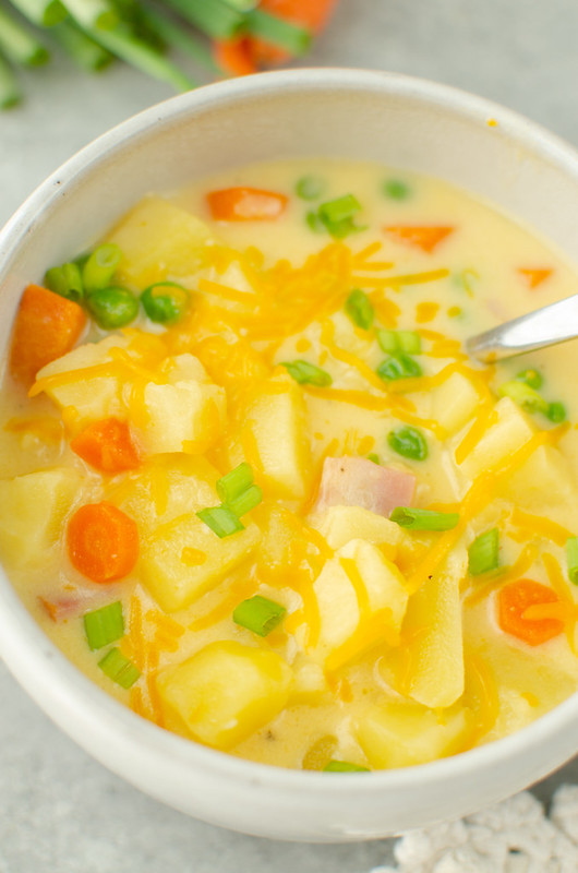 Cheesy Ham Potato Soup - creamy, cheesy soup filled with potatoes, carrots, ham, and peas. It's a big bowl of comfort!