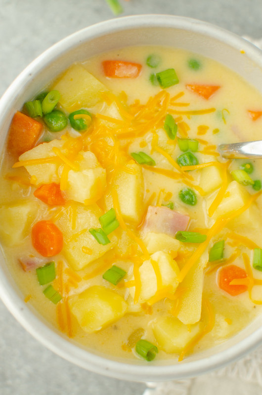 Cheesy Ham Potato Soup - creamy, cheesy soup filled with potatoes, carrots, ham, and peas. It's a big bowl of comfort!