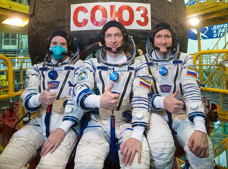 Expedition 64 crew poses during a Soyuz MS-17 spacecraft fit check