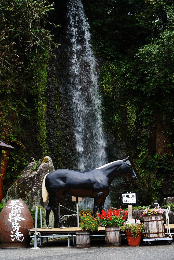 Mannequin horse in front of a waterfall at souvenir shop just outside of Takachiho town