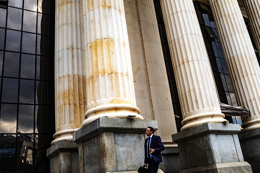 Suited man walking by the Archaeological Museum of Macedonia--Skopje