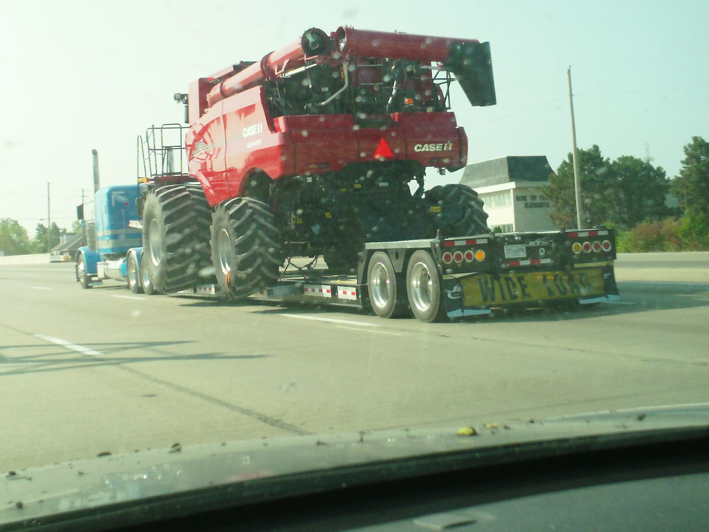 Big red Case Tractor on the highway