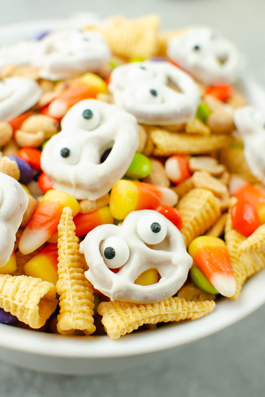 Ghostly Snack Mix - the cutest Halloween snack mix with chocolate covered ghost pretzels, Bugels, peanuts, M&Ms, and candy corn!
