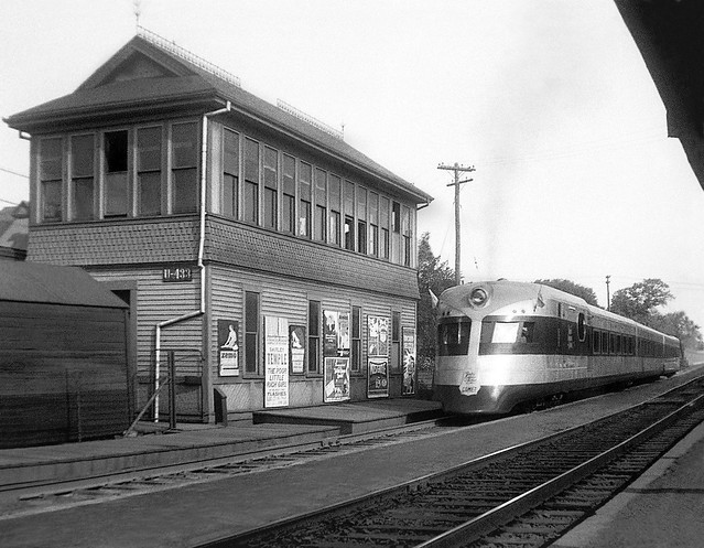 New Haven Railroad Comet is stopped at a station platform by tower SS U433 while operating as an Extra train at Braintree, Massachusetts, 1936