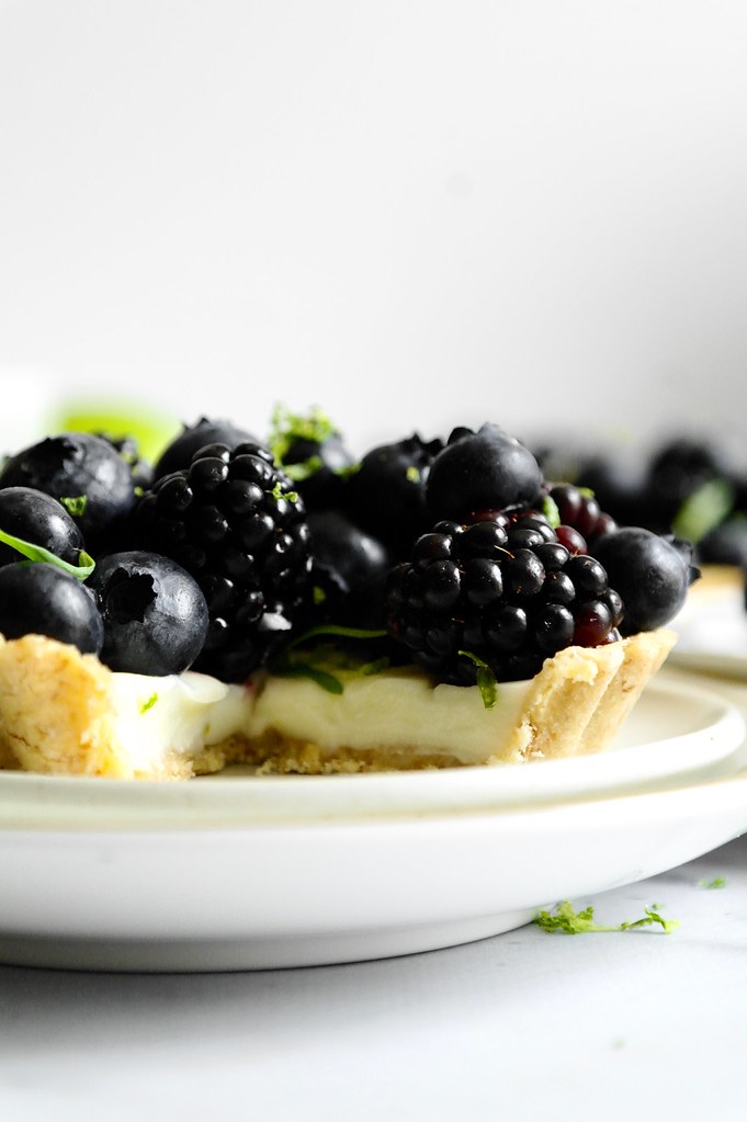 lime tarragon posset tarts with black and blueberries