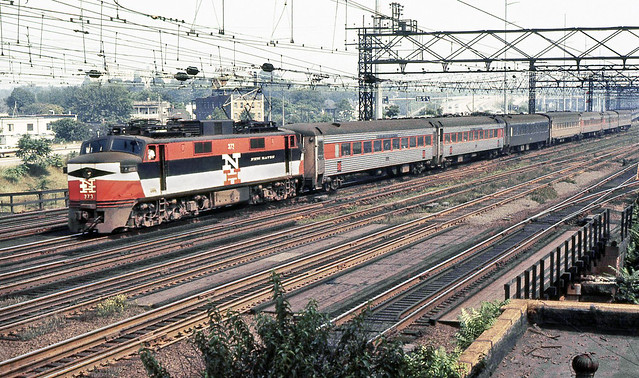 New Haven Railroad GE EP-5 electric locomotive # 373 is seen leading a westbound passenger train on a main line platform track near tower SS38 prior to arriving at the station in Stamford, Connecticut, 1968