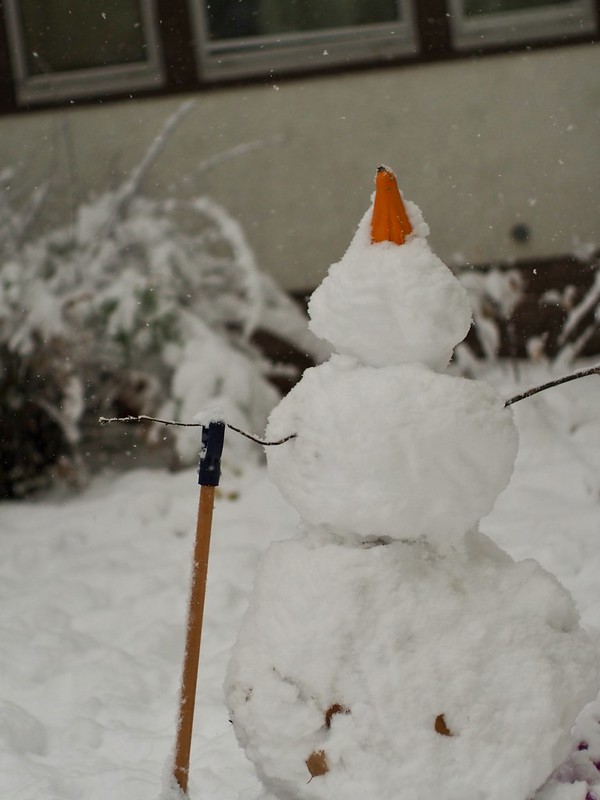 A snowman with a gourd for a hat