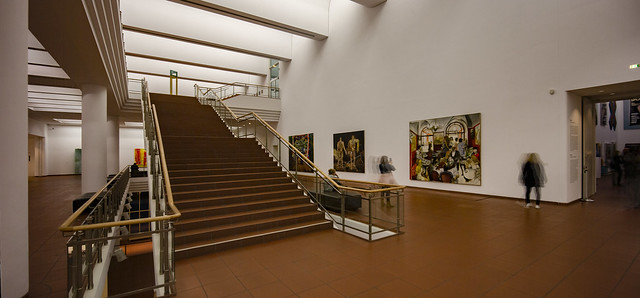 museum stair with bystanders appreciating modern paintings