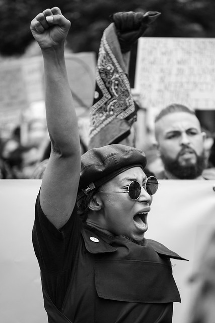 A protester raises her fist