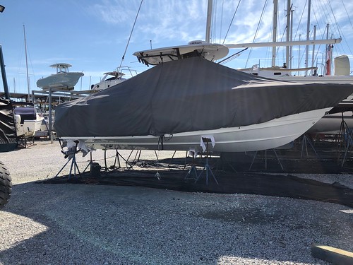 Photo of powerboat in dry dock with a canvas cover