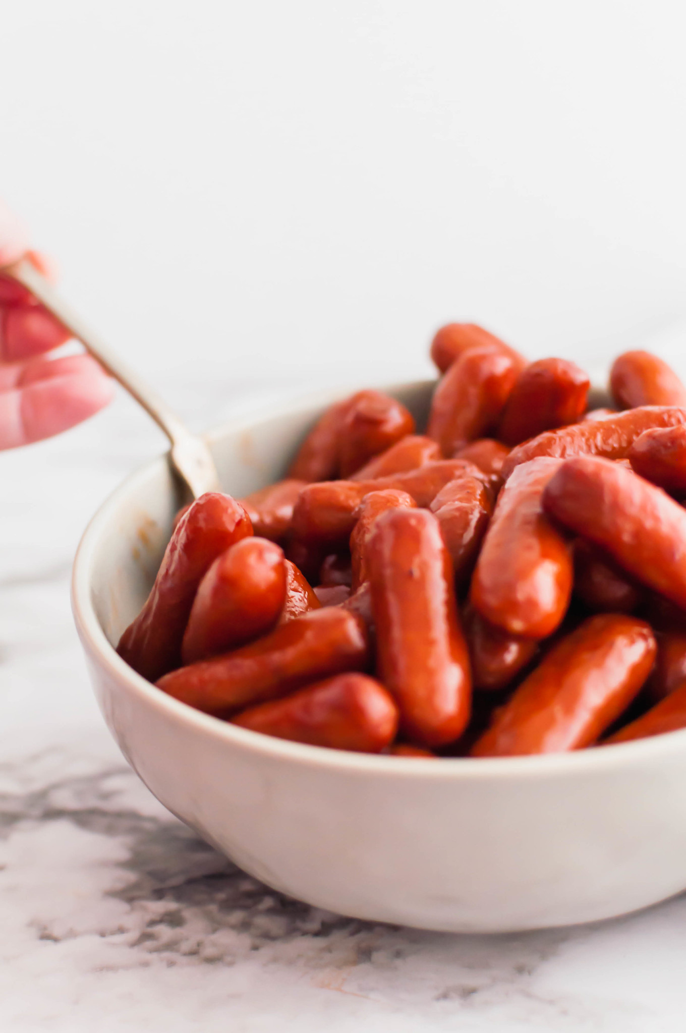 Keep game day fun with these Grape Jelly Little Smokies. Easy to make with just three ingredients and a slow cooker. Great easy slow cooker appetizer for holidays or parties.