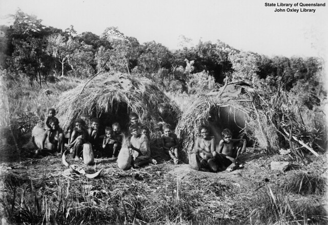 Women and children with shelters at the Bloomfield River Mission, Queensland, 1884