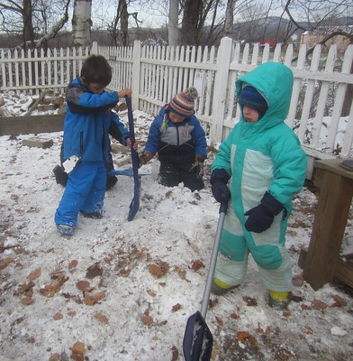 chopping up their snow pile