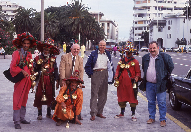 Italians tourists pose with moroccan guys in traditional clothes