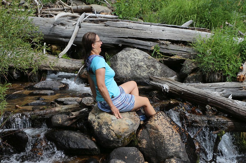 Vicki dips her feet in Chagoopa Creek and is shocked at how cold the water is, but it still felt great on hot feet