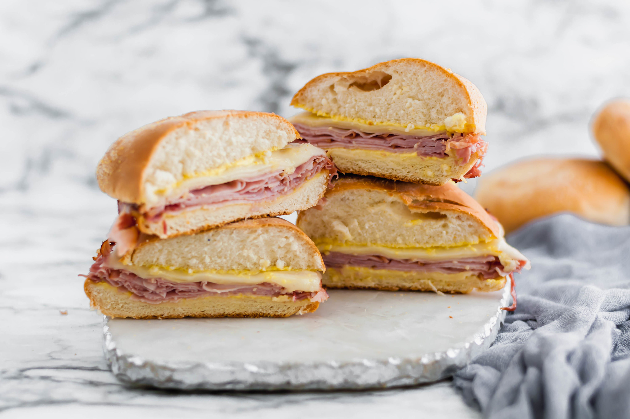 Need an easy lunch or weeknight meal? These Hot Ham and Cheese Sandwiches are the perfect solution. Shaved deli ham (honey ham is my favorite) with melted swiss cheese and a yummy sauce.