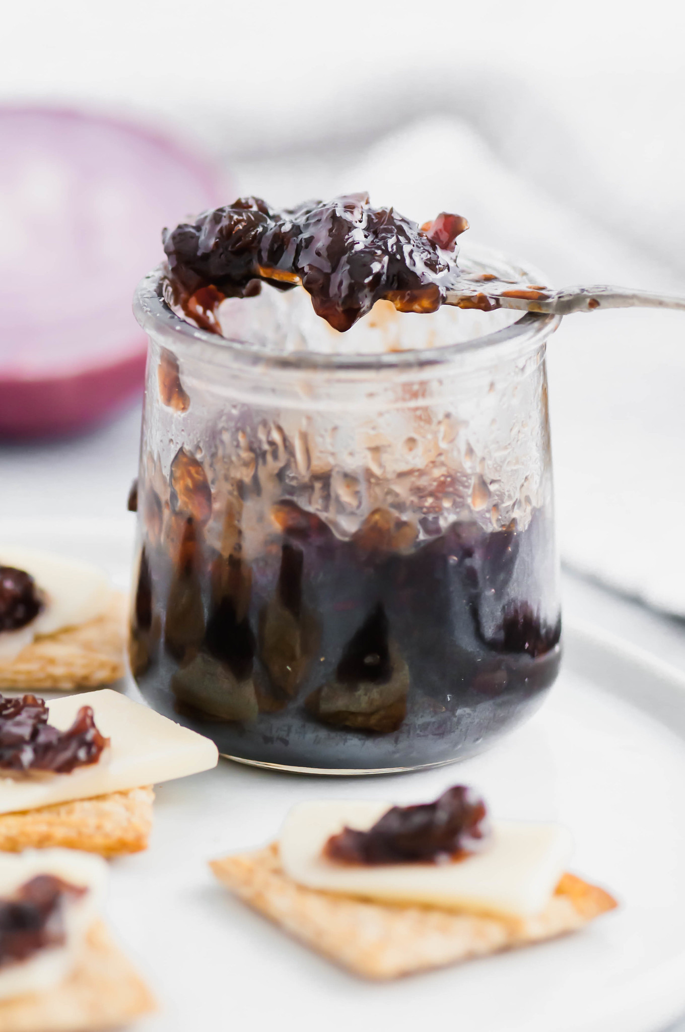 Bacon Onion Jam is a delicious, sweet and savory condiment that is going to blow your mind. Smoky bacon, red onions, sugar and vinegar are cooked down to create a thick, caramelized jam that is delicious on crackers, sandwiches, brie and more. 