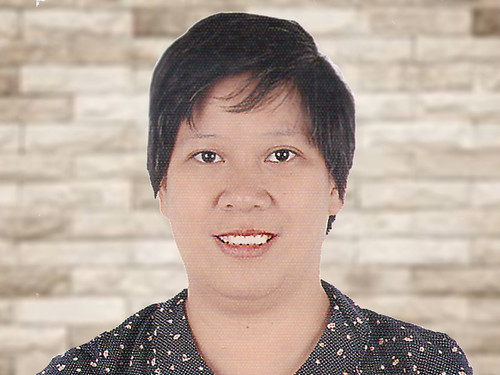 The image shows Ms. Maria Cecilia Zamora wearing black shirt with tiny flower designs. She has fair skin and short hair.