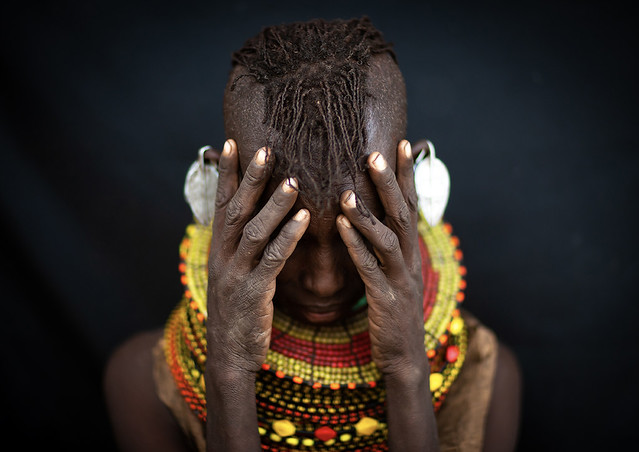 Turkana tribe woman hiding her face, Rift Valley Province, Turkana lake, Kenya