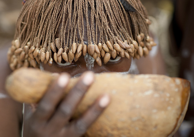 Tharaka tribe woman drinking alcohol in a calabash, Laikipia County, Mount Kenya, Kenya