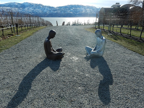 Sculpture of people meditating between the grape vines on the grounds of the Mission Hill Winery