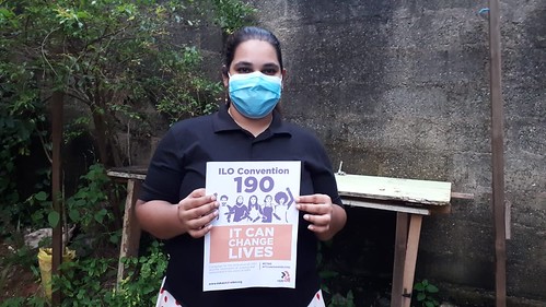 Woman wearing a mask calls for ratification of ILO Convention 190