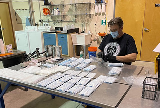 Chris Cooper, a chemical engineer in Green Theme Technologies, assesses the treated masks that are ready for distribution.