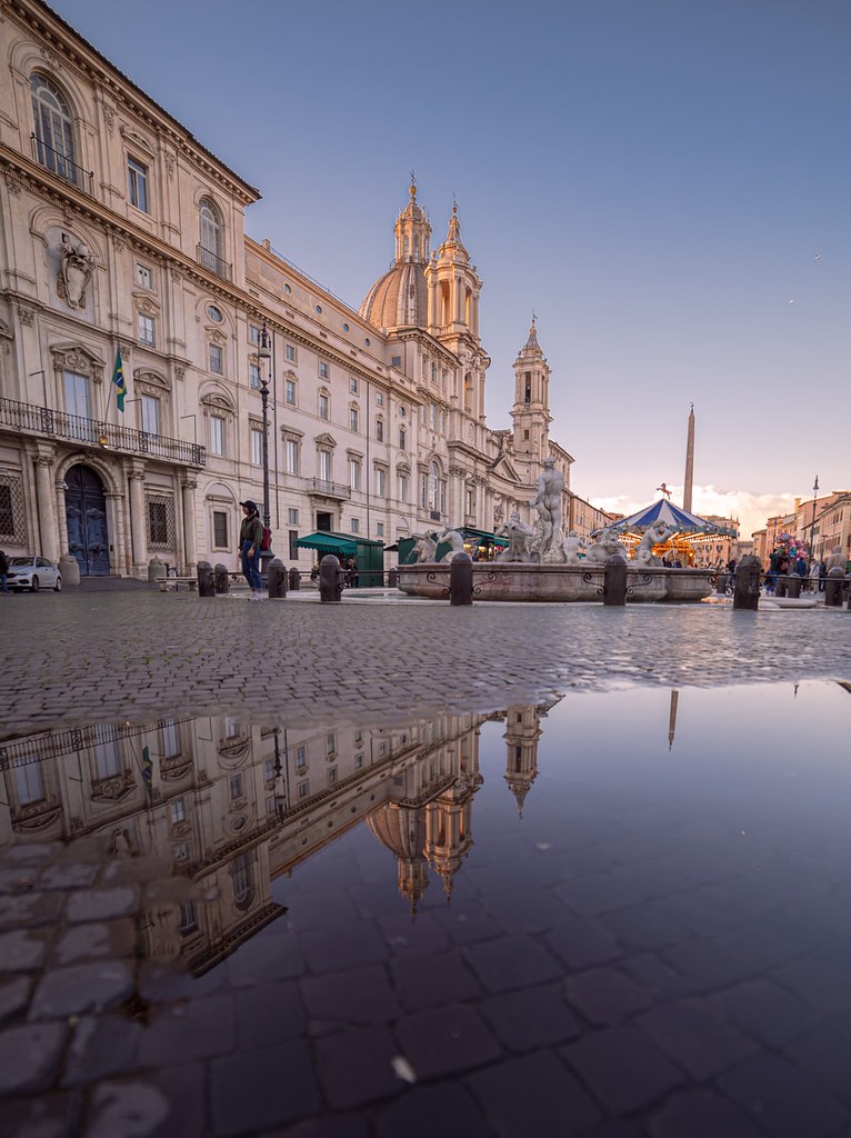 A refletion in a puddle of the church building in Piazza Navona, Roma, Italia