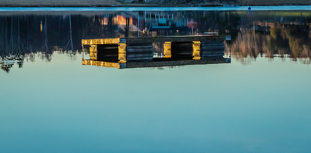 Reflections from a bathing jetty at dawn