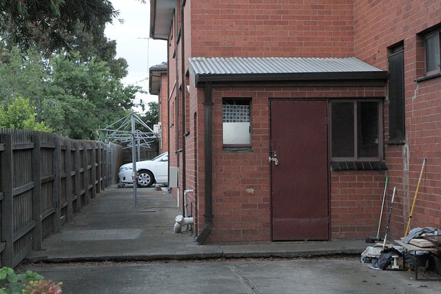 Caretakers toilet locked up outside a block of 1970s walk up flats